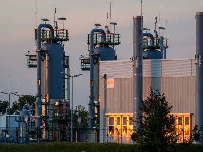 FILED - 28 July 2022, Saxony-Anhalt, Bernburg: The sun rises behind technical equipment of the Katharina natural gas storage facility. German efforts to stock up on gas in light of Russian moves to block the flow of energy supplies are still ticking ahead at a faster clip than proscribed by the government, potentially giving Europe's biggest economy some breathing room. Photo: Klaus-Dietmar Gabbert/dpa