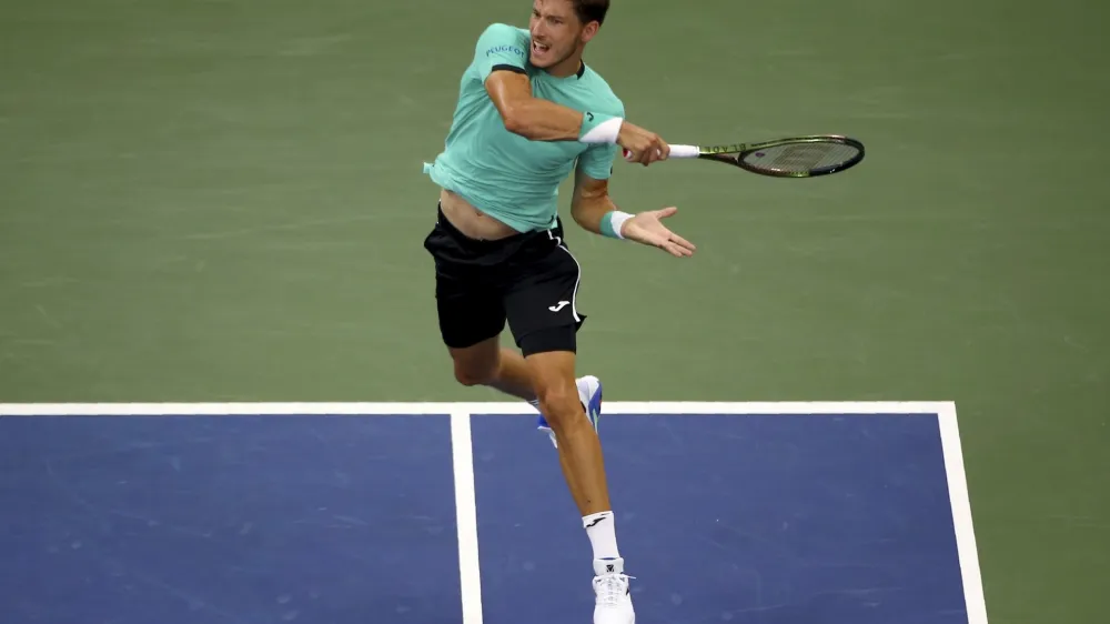 Pablo Carreno Busta, of Spain, returns a shot to Karen Khachanov, of Russia, during the fourth round of the U.S. Open tennis championships, Sunday, Sept. 4, 2022, in New York. (AP Photo/Andres Kudacki)