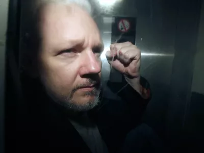 FILE - WikiLeaks founder Julian Assange being taken from court, where he appeared on charges of jumping British bail seven years ago, in London, Wednesday May 1, 2019. Assange will plead guilty to a felony charge in a deal with the U.S. Justice Department that will free him from prison and resolve a long-running legal saga over the publication of a trove of classified documents. (AP Photo/Matt Dunham, File)