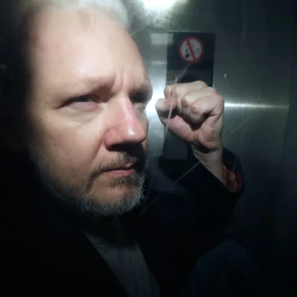 FILE - WikiLeaks founder Julian Assange being taken from court, where he appeared on charges of jumping British bail seven years ago, in London, Wednesday May 1, 2019. Assange will plead guilty to a felony charge in a deal with the U.S. Justice Department that will free him from prison and resolve a long-running legal saga over the publication of a trove of classified documents. (AP Photo/Matt Dunham, File)