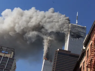 FILE - In this Sept. 11, 2001, file photo, smoke rises from the burning twin towers of the World Trade Center after hijacked planes crashed into the towers in New York City. Sept. 11 victims' relatives are greeting the news of President Donald Trump's now-canceled plan for secret talks with Afghanistan's Taliban insurgents with mixed feelings. (AP Photo/Richard Drew, File)