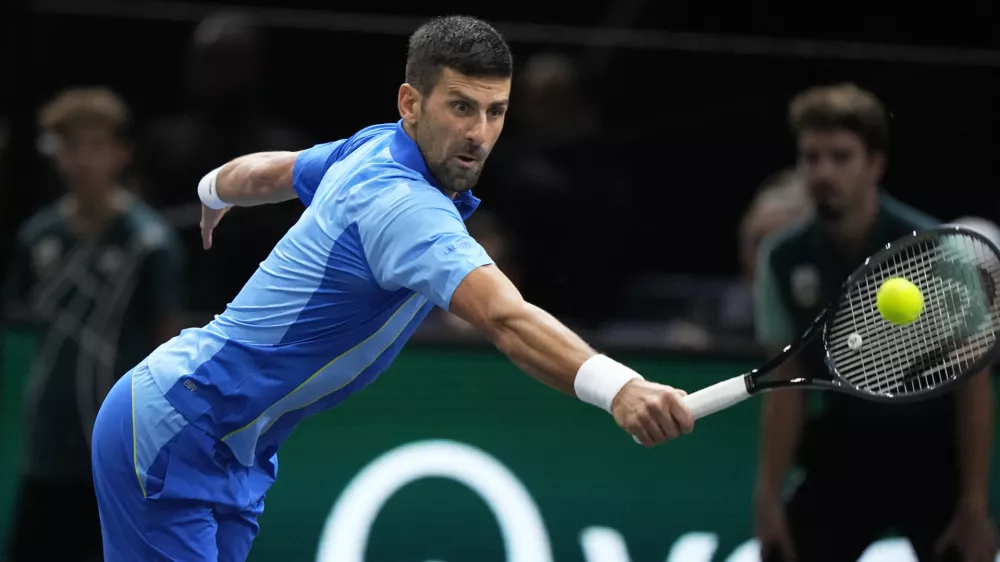 Serbia's Novak Dokovic returns the ball to Denmark's Holger Rune during their quarterfinal match of the Paris Masters tennis tournament, at the Accor Arena in Paris, Friday, Nov. 3, 2023. (AP Photo/Michel Euler)