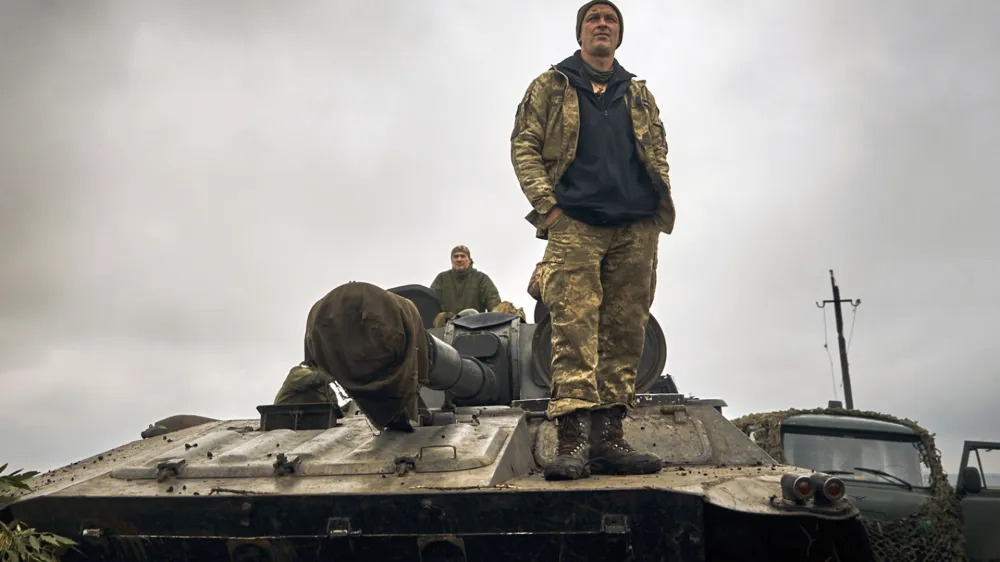 A Ukrainian soldier stands on a tank on the road in the freed territory of the Kharkiv region, Ukraine, Monday, Sept. 12, 2022. Ukrainian troops retook a wide swath of territory from Russia on Monday, pushing all the way back to the northeastern border in some places, and claimed to have captured many Russian soldiers as part of a lightning advance that forced Moscow to make a hasty retreat. (AP Photo/Kostiantyn Liberov)