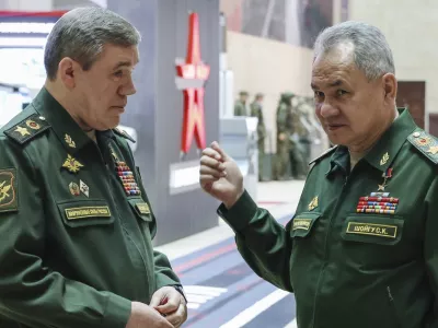 FILE - Russian Defense Minister Sergei Shoigu, right, gestures as he speaks to Russian Chief of General Staff Gen. Valery Gerasimov prior to a meeting Russian President Vladimir Putin with the top military brass in Moscow, Russia, Tuesday, Dec. 19, 2023. The International Criminal Court issued arrest warrants Tuesday for Russia's former defense minister and its military chief of staff for attacking civilian targets in Ukraine.(Sputnik, Kremlin Pool Photo via AP, File)