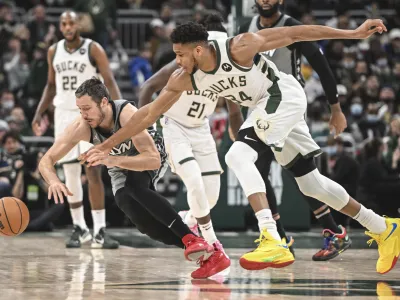 Feb 26, 2022; Milwaukee, Wisconsin, USA; Milwaukee Bucks forward Giannis Antetokounmpo (34) and Brooklyn Nets guard Goran Dragic (9) chase a loose ball in the second quarter at Fiserv Forum. Mandatory Credit: Benny Sieu-USA TODAY Sports