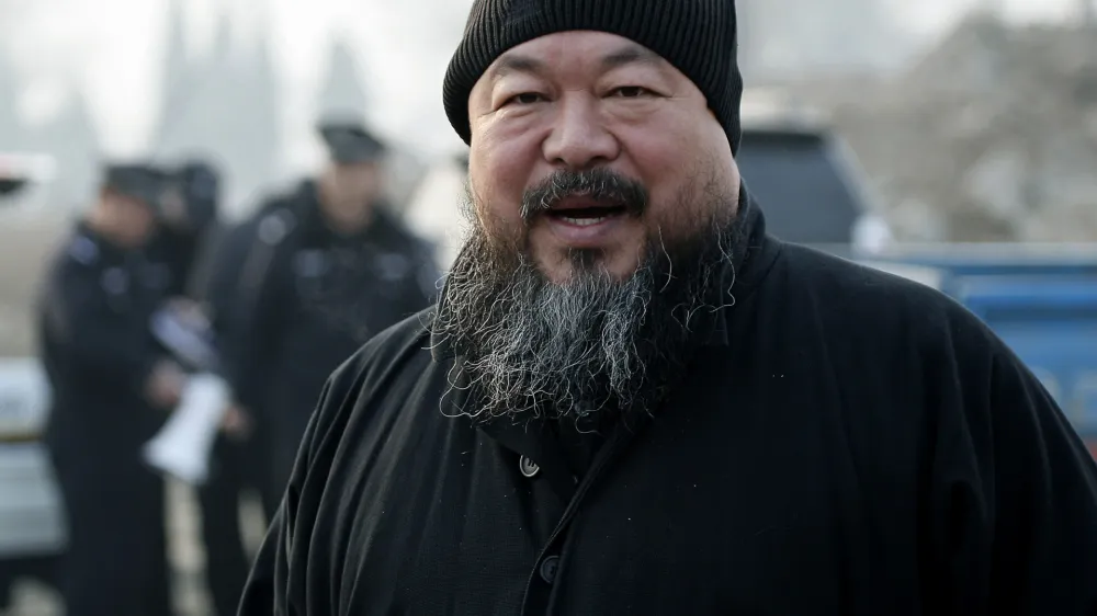 FILE - In this Nov. 17, 2010 file photo, artist Ai Weiwei arrives at the Wenyuhe court to support fellow artist Wu Yuren during his trial in Beijing. China blocked Ai Weiwei, one of its most famous contemporary artists from taking a flight to Hong Kong on Sunday, April 3, 2011 and police later raided his Beijing studio, the man's assistant said. (AP Photo/Andy Wong, File)