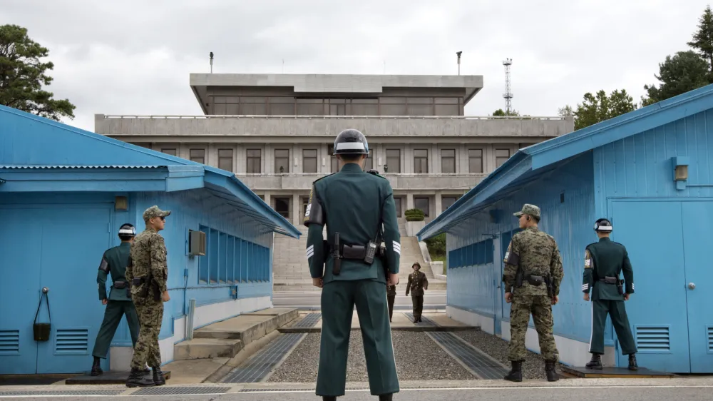 ﻿FILE - In this Sept. 30, 2013, file photo, South Korean soldiers look toward the North Korean side as a North Korean solder approaches the UN truce village building that sits on the border of the Demilitarized Zone (DMZ), the military border separating the two Koreas in Panmunjom, South Korea. The search is on for a venue to host a summit between President Donald Trump and North Koreaâ€™s Kim Jong Un. There are lots of caveats. Trump is being urged not to legitimize Kim by agreeing to talks in North Korea. And itâ€™s risky for Kim to travel to the U.S. So the leaders are more likely to meet in a neutral place, such as the demilitarized zone between the Koreas. (AP Photo/Jacquelyn Martin, File)