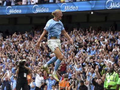 Manchester City's Erling Haaland celebrates scoring his side fourth goal of the game to complete his hat trick during the English Premier League match between Crystal Palace and Manchester City at the Etihad Stadium in Manchester, England, Saturday Aug. 27, 2022. (Nick Potts/PA via AP)