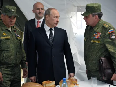 FILE Russian President Vladimir Putin, center, listens to Deputy Defense Minister Dmitry Bulgakov, right, as Defense Minister Sergei Shoigu, left, and Gov. of Baikal region Konstantin Ilkovsky, background, observe military exercises near the Baikal Lake on Wednesday, July 17, 2013. The Russian Defense Ministry on Saturday, Sept. 24, 2022 announced the dismissal of Gen. Dmitry Bulgakov from the post of deputy defense minister in charge of logistics. Bulgakov was replaced by Colonel General Mikhail Mizintsev, who used to be chief of Russia's National Defense Management Center. (Alexei Nikolsky, Sputnik, Kremlin Pool Photo via AP, File)