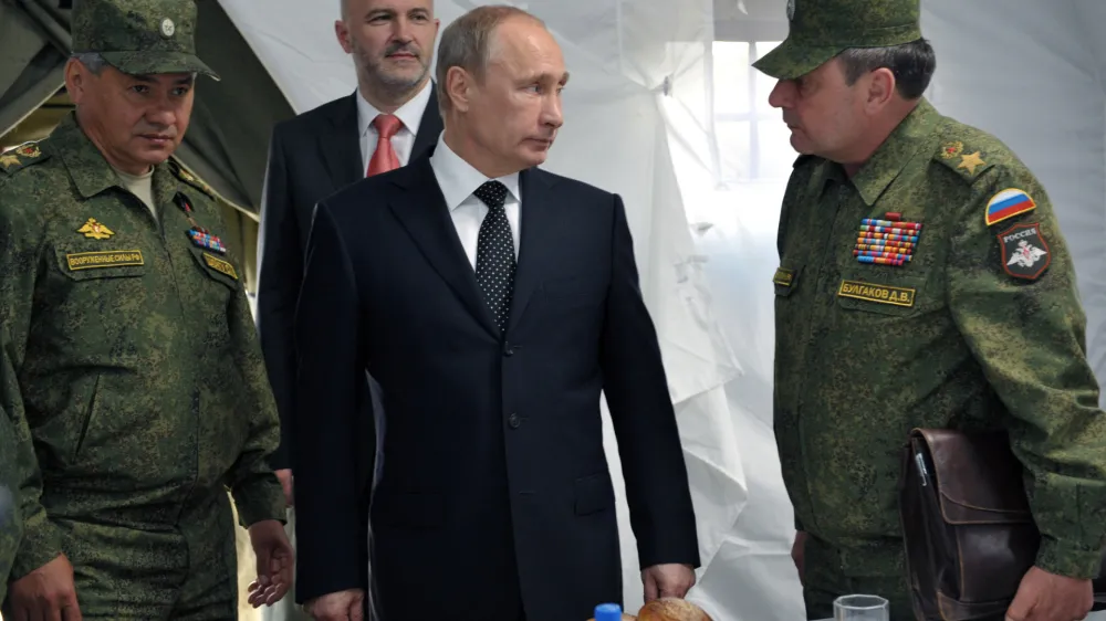 FILE Russian President Vladimir Putin, center, listens to Deputy Defense Minister Dmitry Bulgakov, right, as Defense Minister Sergei Shoigu, left, and Gov. of Baikal region Konstantin Ilkovsky, background, observe military exercises near the Baikal Lake on Wednesday, July 17, 2013. The Russian Defense Ministry on Saturday, Sept. 24, 2022 announced the dismissal of Gen. Dmitry Bulgakov from the post of deputy defense minister in charge of logistics. Bulgakov was replaced by Colonel General Mikhail Mizintsev, who used to be chief of Russia's National Defense Management Center. (Alexei Nikolsky, Sputnik, Kremlin Pool Photo via AP, File)