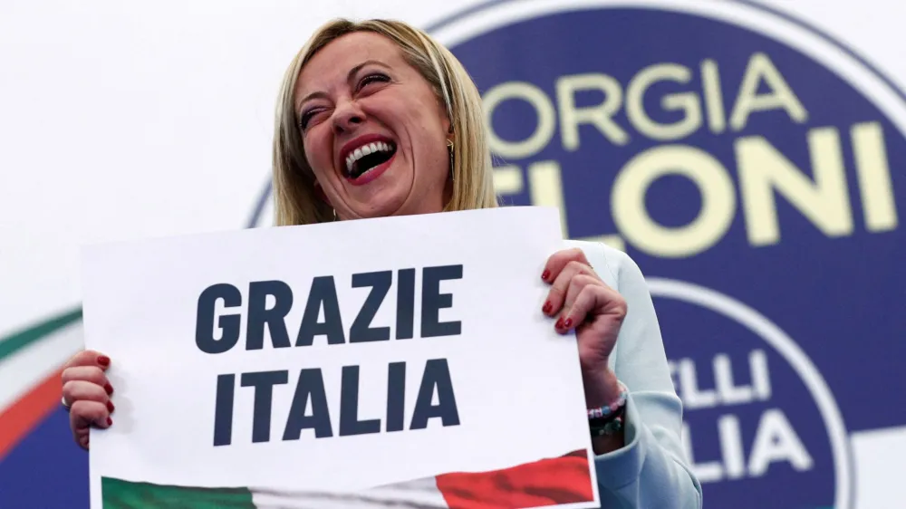 Leader of Brothers of Italy Giorgia Meloni holds a sign at the party's election night headquarters, in Rome, Italy September 26, 2022. REUTERS/Guglielmo Mangiapane   TPX IMAGES OF THE DAY