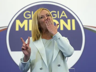 Far-Right party Brothers of Italy's leader Giorgia Meloni flashes the victory sign at her party's electoral headquarters in Rome, early Monday, Sept. 26, 2022. Italian voters rewarded Giorgia Meloni's euroskeptic party with neo-fascist roots, propelling the country toward what likely would be its first far-right-led government since World War II, based on partial results Monday from the election for Parliament. (AP Photo/Gregorio Borgia)