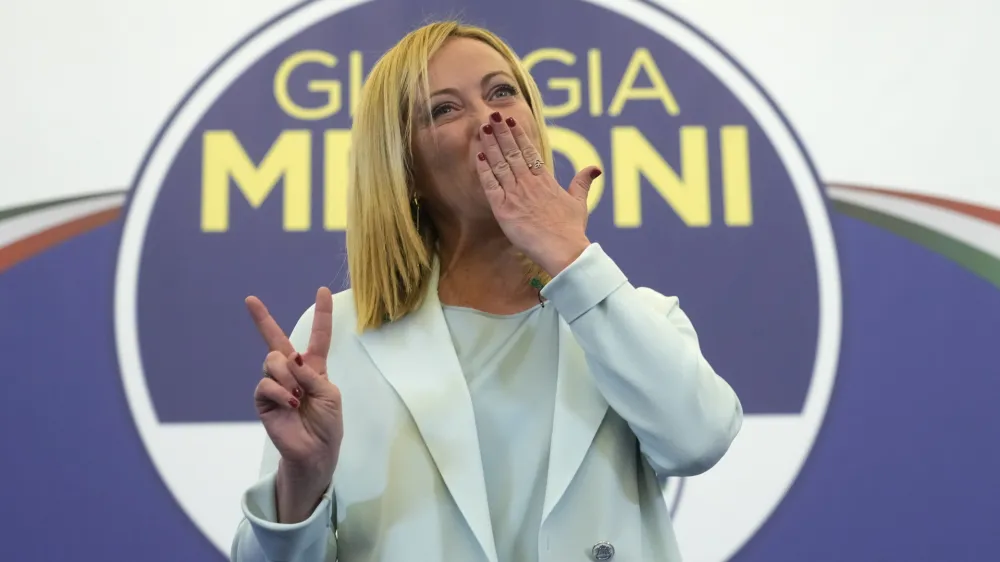 Far-Right party Brothers of Italy's leader Giorgia Meloni flashes the victory sign at her party's electoral headquarters in Rome, early Monday, Sept. 26, 2022. Italian voters rewarded Giorgia Meloni's euroskeptic party with neo-fascist roots, propelling the country toward what likely would be its first far-right-led government since World War II, based on partial results Monday from the election for Parliament. (AP Photo/Gregorio Borgia)