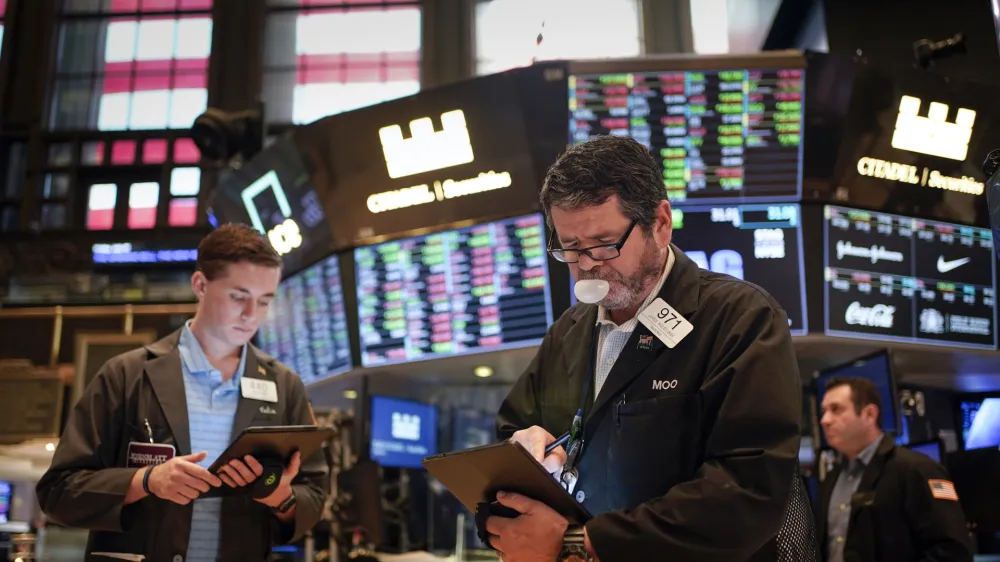 Traders work on the floor at the New York Stock Exchange in New York, Friday, July 1, 2022. Stocks are off to a weak start on Friday, continuing a dismal streak that pushed Wall Street into a bear market last month as traders worry that inflation will be tough to beat and that a recession could be on the way as well. (AP Photo/Seth Wenig)