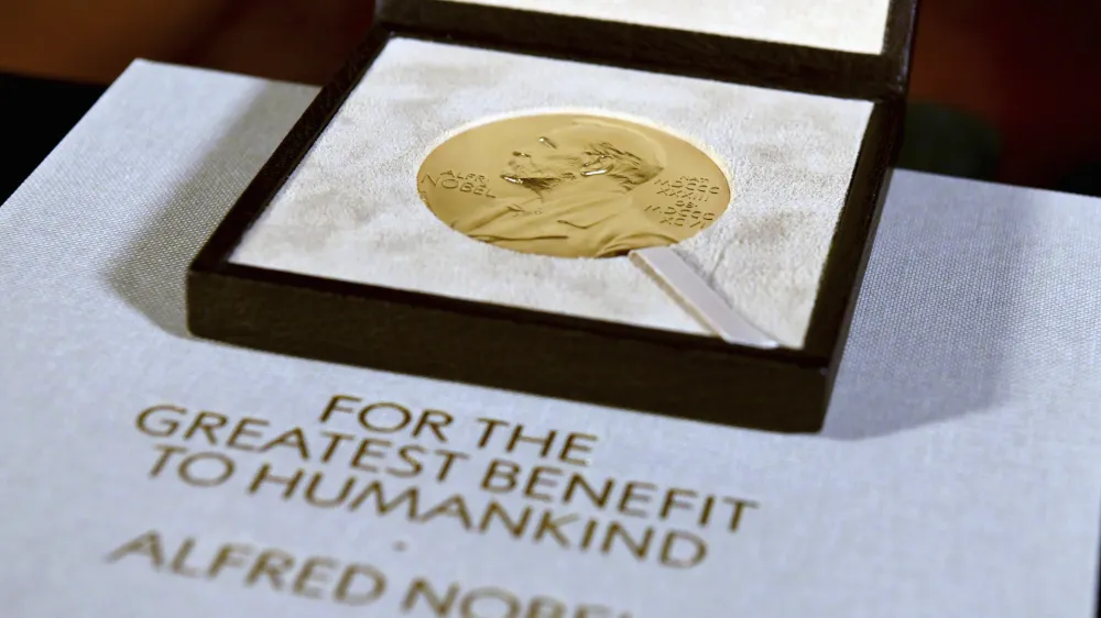 FILE - A Nobel diploma and medal are displayed, Tuesday, Dec. 8, 2020, during a ceremony in New York. (Angela Weiss/Pool Photo via AP, File)