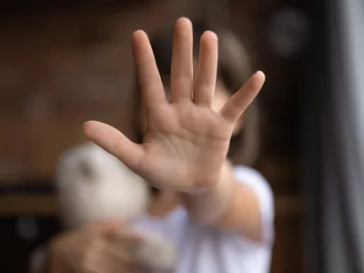 Crop close up of little girl child stretch hand show no gesture protest against domestic violence. Small teen child stand against discrimination or school abuse. Childhood problem, voice concept.