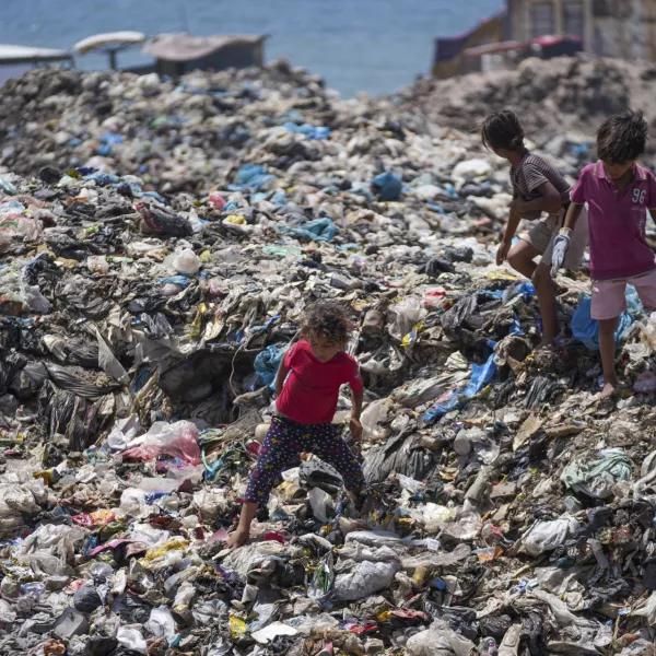 Palestinian kids sort through trash at a landfill in Nuseirat refugee camp, Gaza Strip, Thursday, June 20, 2024. Israel's war in Gaza has decimated the strip's sanitation system while simultaneously displacing the vast majority of the population, leaving many Palestinians living in tent camps nearby water contaminated with sewage and growing piles of garbage. (AP Photo/Abdel Kareem Hana)