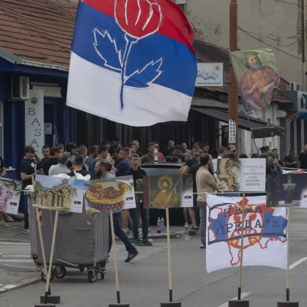 Right-wing extremists gather on a street in central Belgrade, Serbia, Thursday, June 27, 2024. Serbian police on Thursday banned a festival that promotes cultural exchange with Kosovo, in a sign of growing nationalism and government pressure on liberal voices in the Balkan country. The police ban came after several dozen right-wing extremists gathered outside the festival venue, seeking to prevent its holding while waving Serbian flags. (AP Photo/Marko Drobnjakovic)