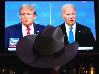 Roger Strassburg, of Scottsdale, Ariz., wears a cowboy hat as he watches the presidential debate between President Joe Biden and Republican presidential candidate former President Donald Trump at a debate watch party Thursday, June 27, 2024, in Scottsdale, Ariz. (AP Photo/Ross D. Franklin)