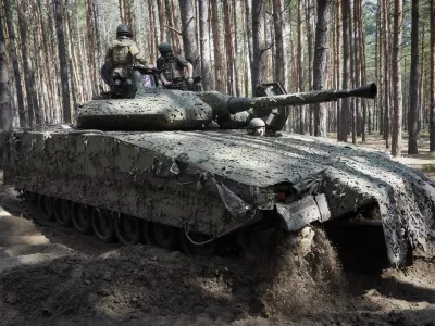 FILE - Ukrainian soldiers ride in a combat vehicle near the front line in the Kharkiv region of Ukraine, on Tuesday, June 18, 2024. Russia's offensive near the city of Kharkiv that began in May has apparently lost momentum after Ukraine bolstered its forces in the area by redeploying troops there from other sectors. (AP Photo/Andrii Marienko, File)