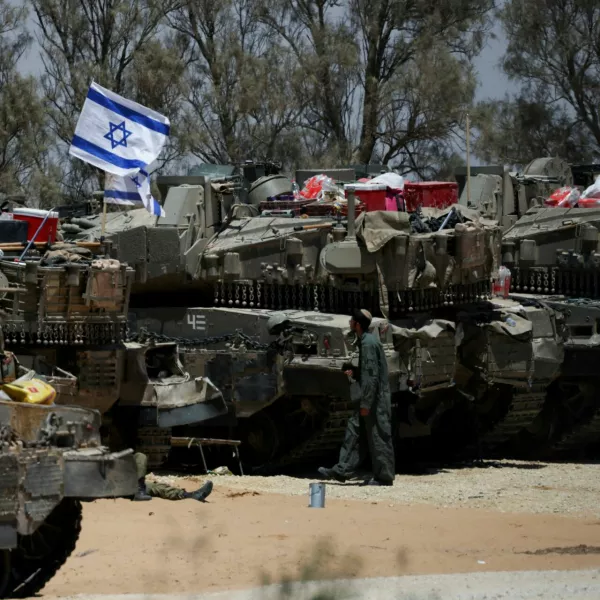 FILE PHOTO: An Israeli soldier walks near military vehicles, amid the ongoing conflict between Israel and the Palestinian Islamist group Hamas, near Israel's border with Gaza in southern Israel, May 29, 2024. REUTERS/Ronen Zvulun/File Photo