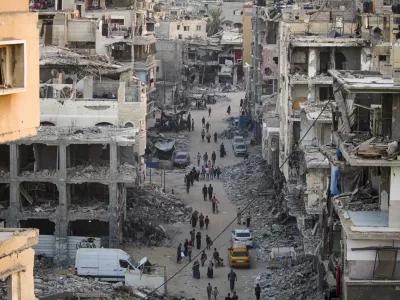 Palestinians displaced by the Israeli bombardment of the Gaza Strip walk through a street market in Khan Younis, southern Gaza Strip Saturday, June 29, 2024. (AP Photo/Jehad Alshrafi)