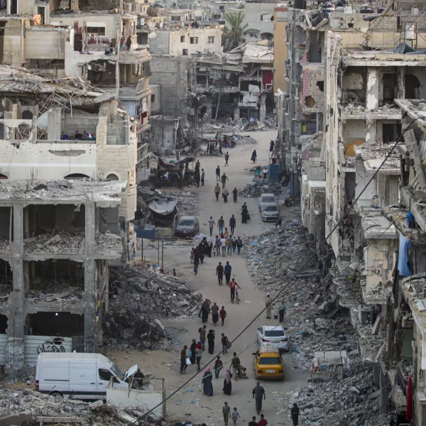 Palestinians displaced by the Israeli bombardment of the Gaza Strip walk through a street market in Khan Younis, southern Gaza Strip Saturday, June 29, 2024. (AP Photo/Jehad Alshrafi)