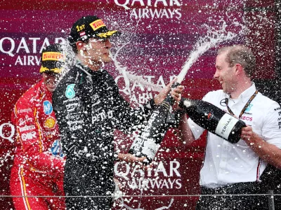 Formula One F1 - Austrian Grand Prix - Red Bull Ring, Spielberg, Austria - June 30, 2024 Mercedes' George Russell celebrates on the podium after winning the Austrian Grand Prix REUTERS/Florion Goga