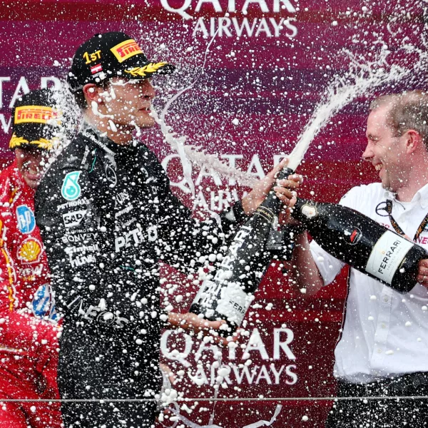 Formula One F1 - Austrian Grand Prix - Red Bull Ring, Spielberg, Austria - June 30, 2024 Mercedes' George Russell celebrates on the podium after winning the Austrian Grand Prix REUTERS/Florion Goga