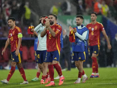 Spain's players react at the end of a round of sixteen match at the Euro 2024 soccer tournament against Georgia in Cologne, Germany, Sunday, June 30, 2024. Spain won the game 4-1. AP Photo/Frank Augstein)