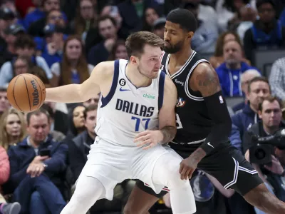 Nov 15, 2022; Dallas, Texas, USA; Dallas Mavericks guard Luka Doncic (77) controls the ball as LA Clippers guard Paul George (13) defends during the second half at American Airlines Center. Mandatory Credit: Kevin Jairaj-USA TODAY Sports