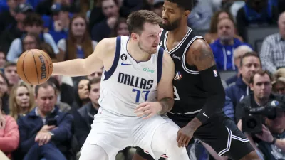 Nov 15, 2022; Dallas, Texas, USA; Dallas Mavericks guard Luka Doncic (77) controls the ball as LA Clippers guard Paul George (13) defends during the second half at American Airlines Center. Mandatory Credit: Kevin Jairaj-USA TODAY Sports