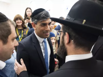 Britain's Prime Minister Rishi Sunak meets locals, during a visit to Machzike Hadath Synagogue, in Golders Green, while on the general election campaign trail, in north west London, Sunday June 30, 2024. (James Manning/Pool Photo via AP)