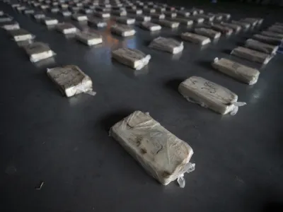 Confiscated cocaine is shown to the press at a police hangar in Buenos Aires, Argentina, Thursday, Oct. 6, 2022. Police say they arrested three men from Peru and three from Paraguay with almost half a ton of pure cocaine brought by land from Peru that was going to be cut and distributed in Buenos Aires. (AP Photo/Victor R. Caivano)