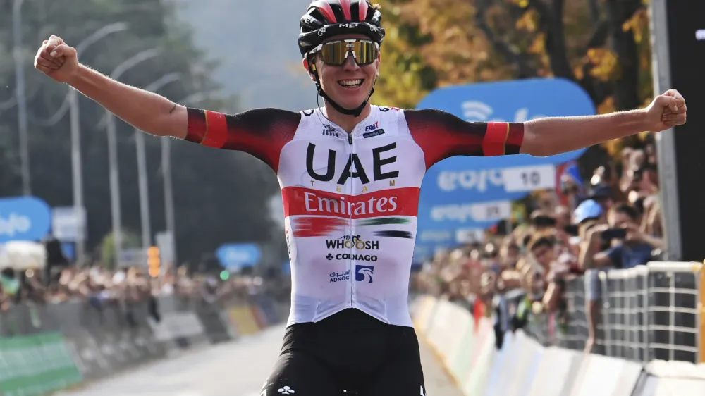 Tadej Pogacar celebrates as he crosses the finish line to win Il Lombardia cycling race from Bergamo to Como, Italy, Saturday, Oct. 8, 2022. (Gian Mattia D'Alberto/LaPresse via AP)