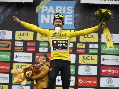 ﻿Slovenian rider Primoz Roglic of Jumbo Visma cycling team celebrates on the podium with his son Lev, after winning the Paris-Nice cycling race, in Nice, southern France, Sunday, March, 13, 2022. (AP Photo/Jean Francois Badias)