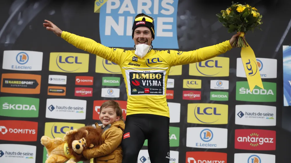 ﻿Slovenian rider Primoz Roglic of Jumbo Visma cycling team celebrates on the podium with his son Lev, after winning the Paris-Nice cycling race, in Nice, southern France, Sunday, March, 13, 2022. (AP Photo/Jean Francois Badias)