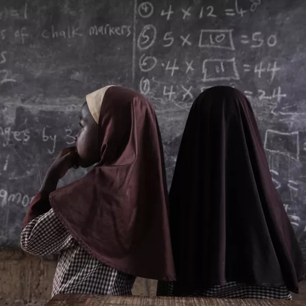 Students of Excellent Moral School attempt to answer a mathematics question on a blackboard inside a dimly lit classroom in Ibadan, Nigeria, Tuesday, May 28, 2024. Schools like Excellent Moral operate in darkness due to zero grid access, depriving students of essential tools like computers. (AP Photo/Sunday Alamba)