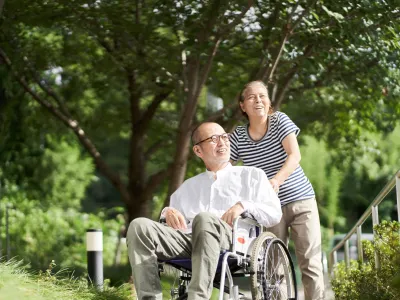 Family supporting the elderly in wheelchairs