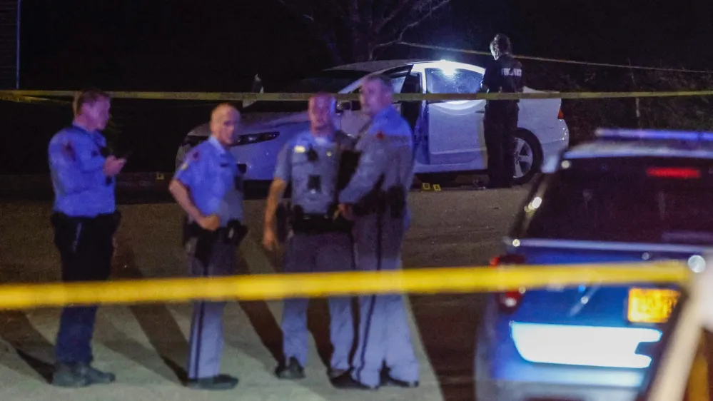 Law enforcement officers work a crime scene in the Hedingham neighborhood and Neuse River Trail area in Raleigh, N.C., after five people were shot and killed Thursday, Oct. 13, 2022. (Travis Long/The News & Observer via AP)