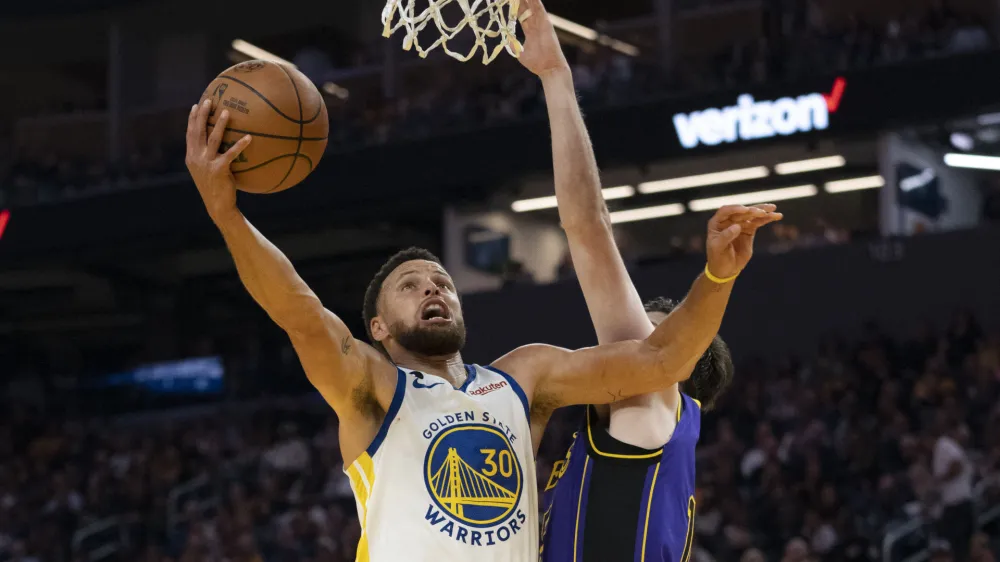 October 18, 2022; San Francisco, California, USA; Golden State Warriors guard Stephen Curry (30) shoots the basketball against Los Angeles Lakers forward Matt Ryan (37) during the second quarter at Chase Center. Mandatory Credit: Kyle Terada-USA TODAY Sports