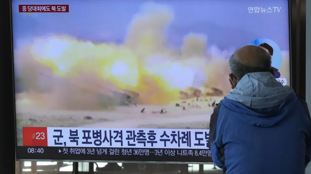 A TV screen shows a file image of North Korea's military exercise during a news program at the Seoul Railway Station in Seoul, South Korea, Wednesday, Oct. 19, 2022. North Korea fired artillery shells near its sea boundaries with South Korea late Tuesday, a day after the South began annual military drills to better deal with North Korean provocations. (AP Photo/Ahn Young-joon)