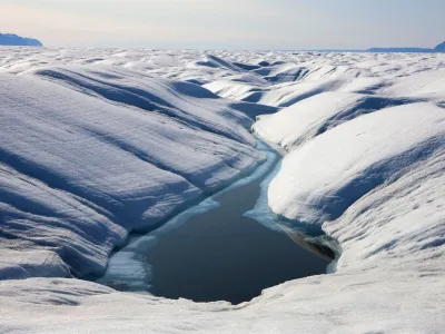 A lake of meltwater on the surface of the Petermann Glacier in this July 6, 2009 handout photo. An ice island four times the size of Manhattan broke off from one of Greenland's two main glaciers including the Petermann Glacier, scientists said on August 6, 2010 in the biggest such event in the Arctic in nearly 50 years. REUTERS/Nick Cobbing/Greenpeace/Handout (GREENLAND - Tags: ENVIRONMENT) NO COMMERCIAL USE. NO SALES. NO ARCHIVES. FOR EDITORIAL USE ONLY. NOT FOR SALE FOR MARKETING OR ADVERTISING CAMPAIGNS