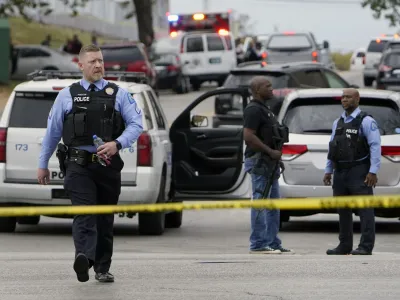 Law enforcement investigate the scene of a shooting at Central Visual and Performing Arts High School Monday, Oct. 24, 2022, in St. Louis. (AP Photo/Jeff Roberson)