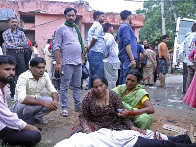 Women mourn next to the body of a relative outside the Sikandrarao hospital in Hathras district about 350 kilometers (217 miles) southwest of Lucknow, India, Tuesday, July 2, 2024. At least 60 people are dead and scores are injured after a stampede at a religious gathering of thousands of people in northern India, officials said Tuesday.(AP Photo/Manoj Aligadi)