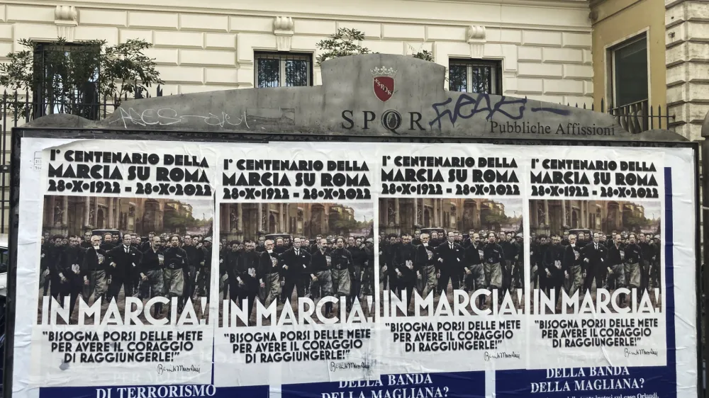 Posters commemorating the 100th anniversary of the March on Rome bearing a picture of Italian Fascist Dictator Benito Mussolini reading: "Marching!" with a quote by Mussolini "you have to set yourself goals to have the courage to reach them" are posted on the Rome's public billboard space, Thursday, Oct. 27, 2022. (AP Photo/Gregorio Borgia)