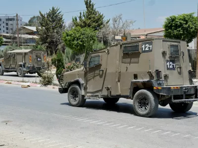 An Israeli military vehicle drives on a street after an Israeli raid at Nur Shams camp, in Tulkarm, in the Israeli-occupied West Bank, July 1, 2024. REUTERS/Raneen Sawafta