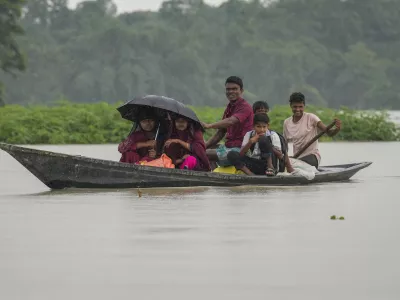 People travel on a country boat in the flood water in Morigaon district in the northeastern Indian state of Assam, India, Wednesday, July 3, 2024. (AP Photo/Anupam Nath)