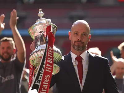 FILE - Manchester United's head coach Erik ten Hag celebrates with the trophy after winning the English FA Cup final soccer match between Manchester City and Manchester United at Wembley Stadium in London, on May 25, 2024. Manchester United manager Erik ten Hag has signed a contract extension through to 2026, the Premier League club said. (AP Photo/Ian Walton)