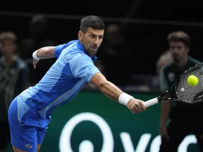 Serbia's Novak Dokovic returns the ball to Denmark's Holger Rune during their quarterfinal match of the Paris Masters tennis tournament, at the Accor Arena in Paris, Friday, Nov. 3, 2023. (AP Photo/Michel Euler)